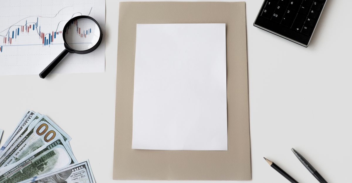 Flat lay of financial tools and blank paper for planning or mockup.