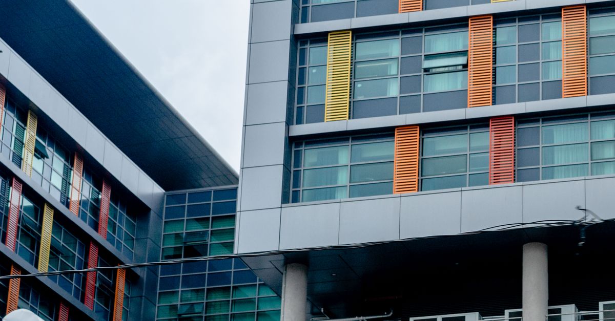 Modern building with colorful facade and glass windows showcasing urban architecture.