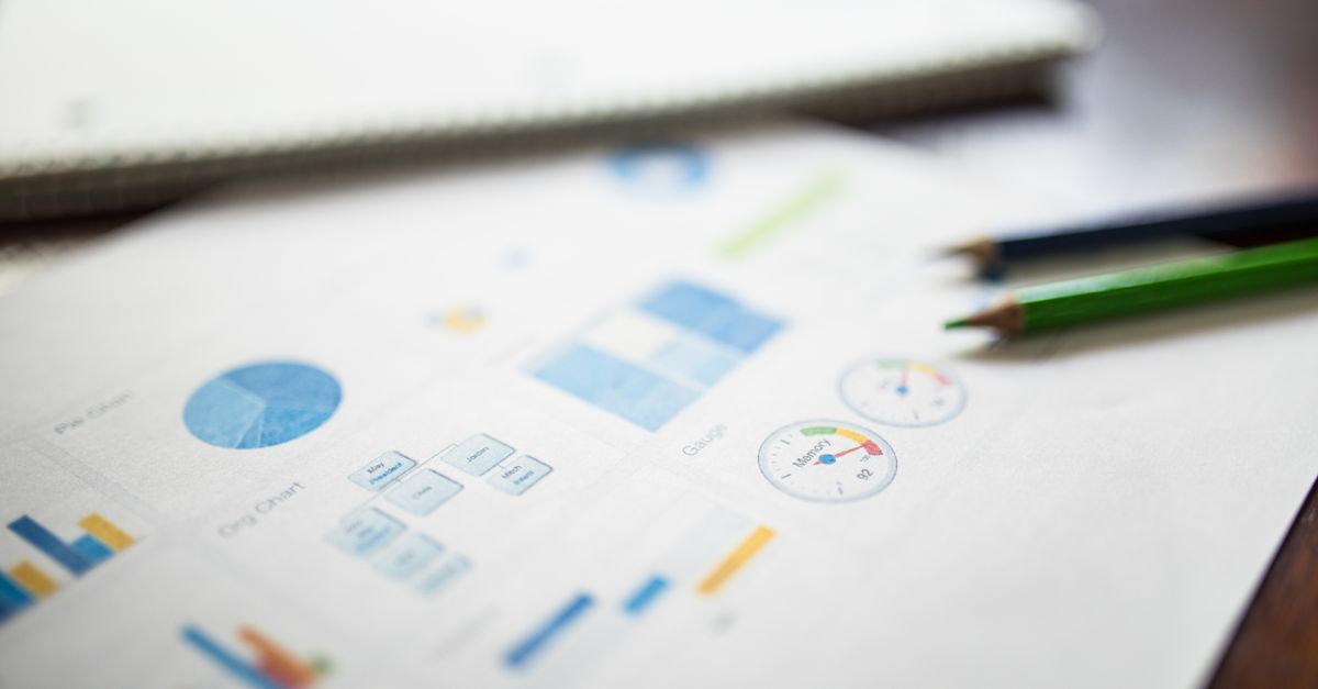 Illustration of a business financial report featuring various charts and graphs on paper.